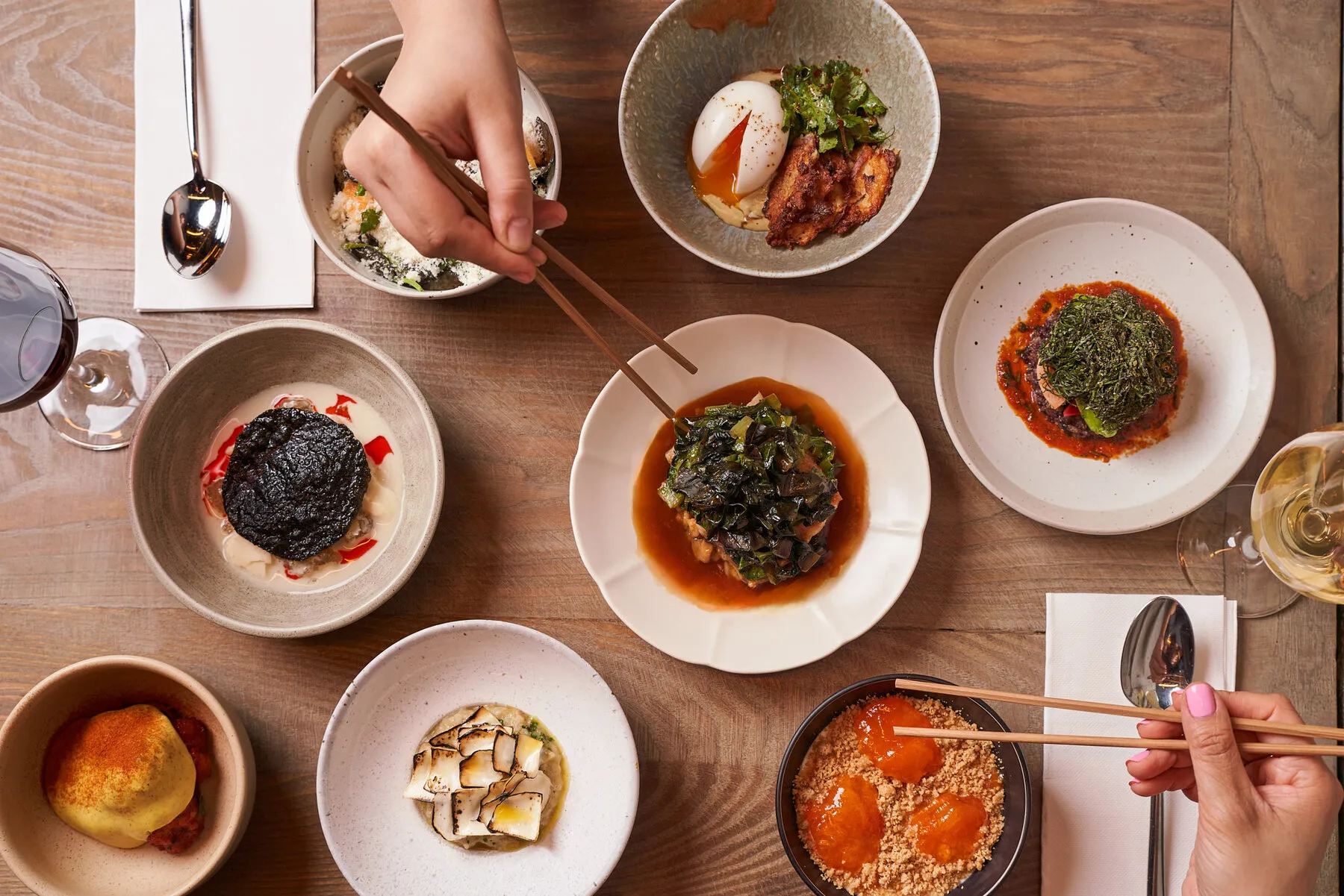 An array of modern Korean small plates and dishes from Atoboy, showcasing the restaurant's tasting menu format.