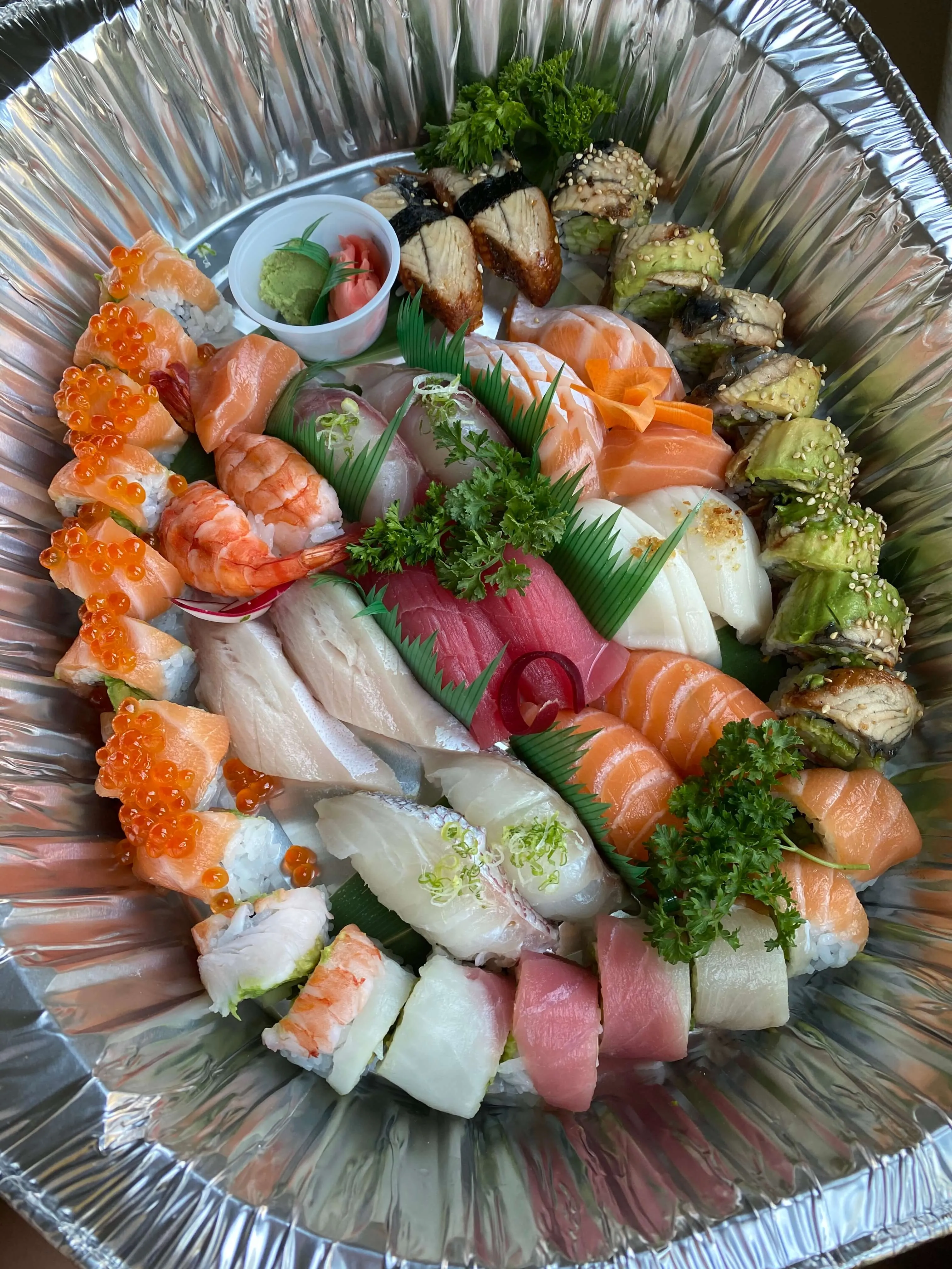 An assortment of sushi and rolls on a traditional plate at Osaka Mansun in Austin