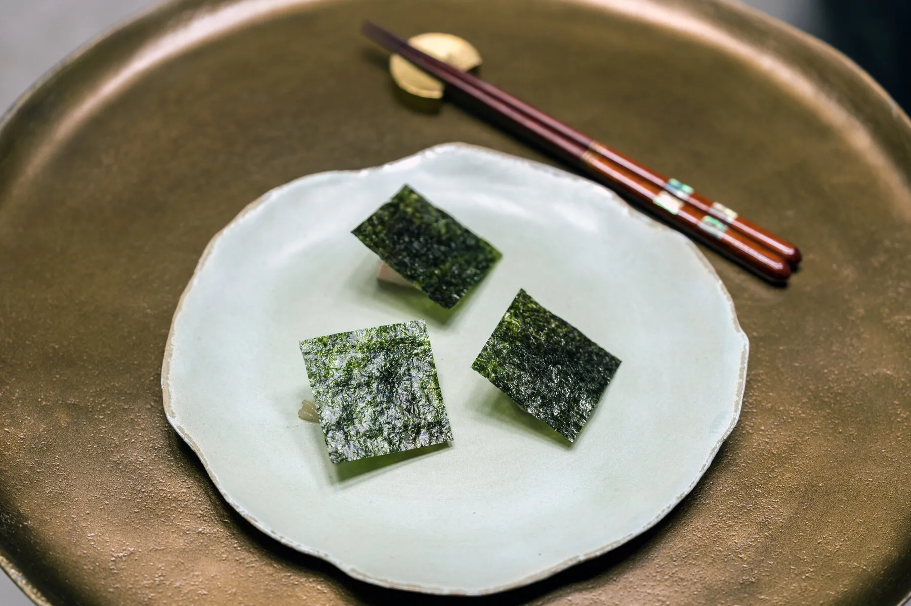 An intricate, modern Korean dish served at Atomix, presented in unique ceramicware with elegant plating.