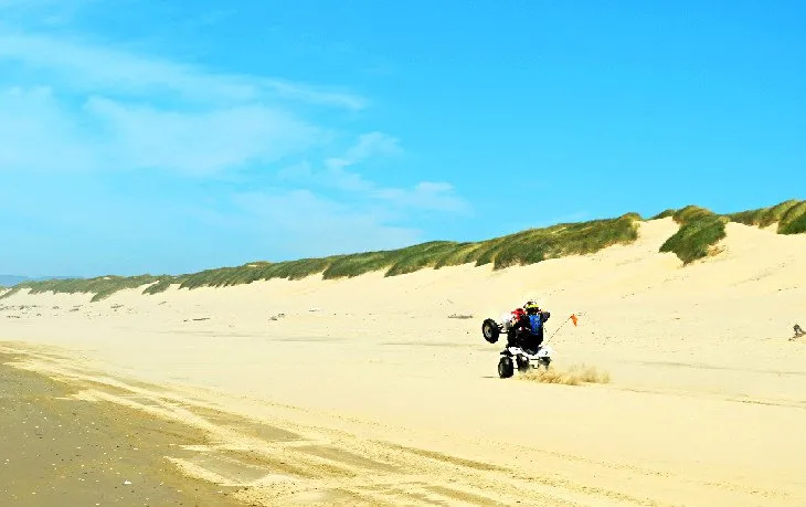 An OHV rider navigates the large sand dunes at the Oregon Dunes National Recreation Area
