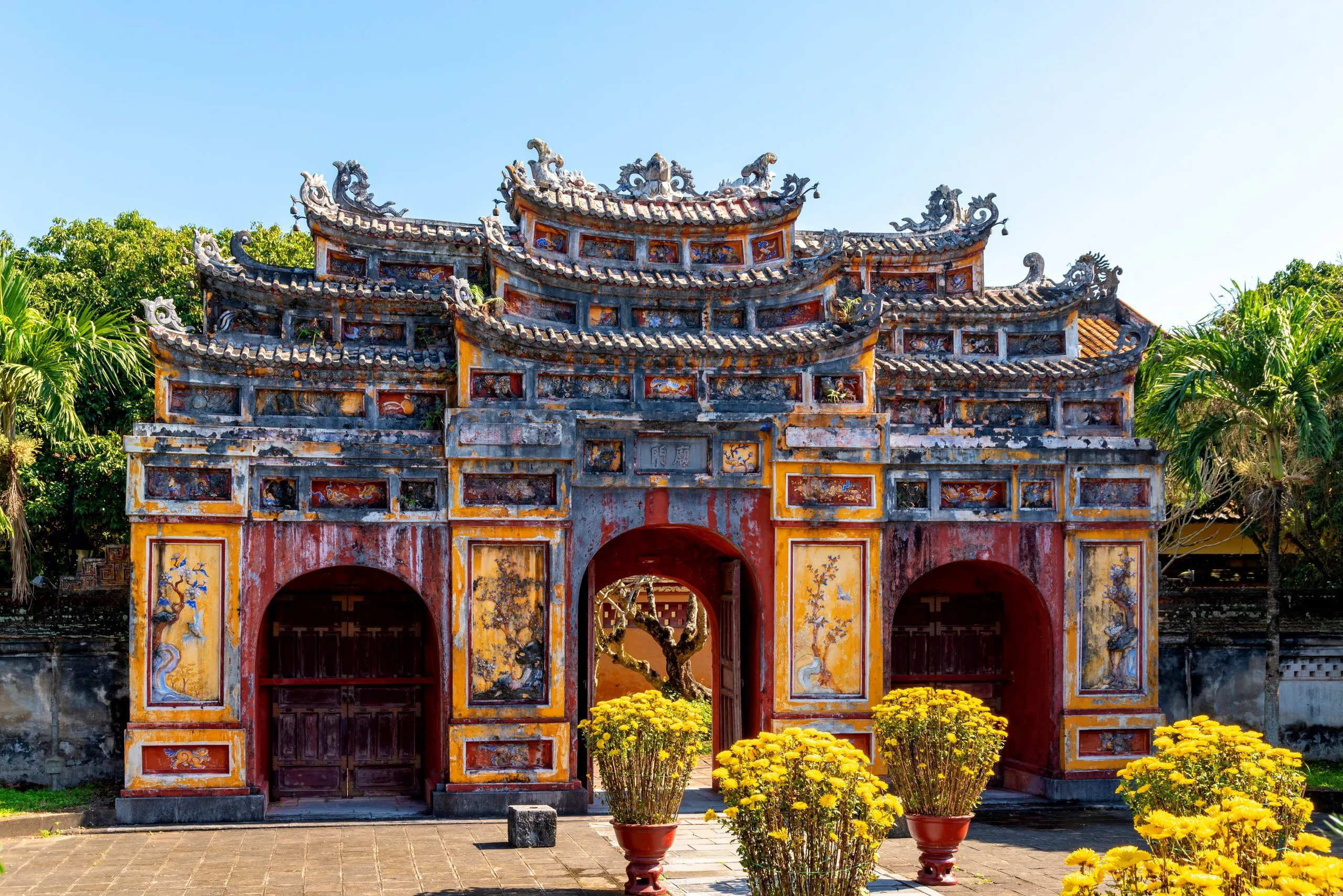 An ornate gate within the Imperial City of Hue, Vietnam, showcasing the architectural legacy of the Nguyen dynasty.