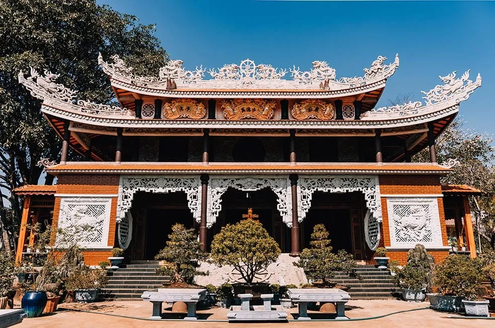 An ornate multi-tiered temple structure in Vietnam.