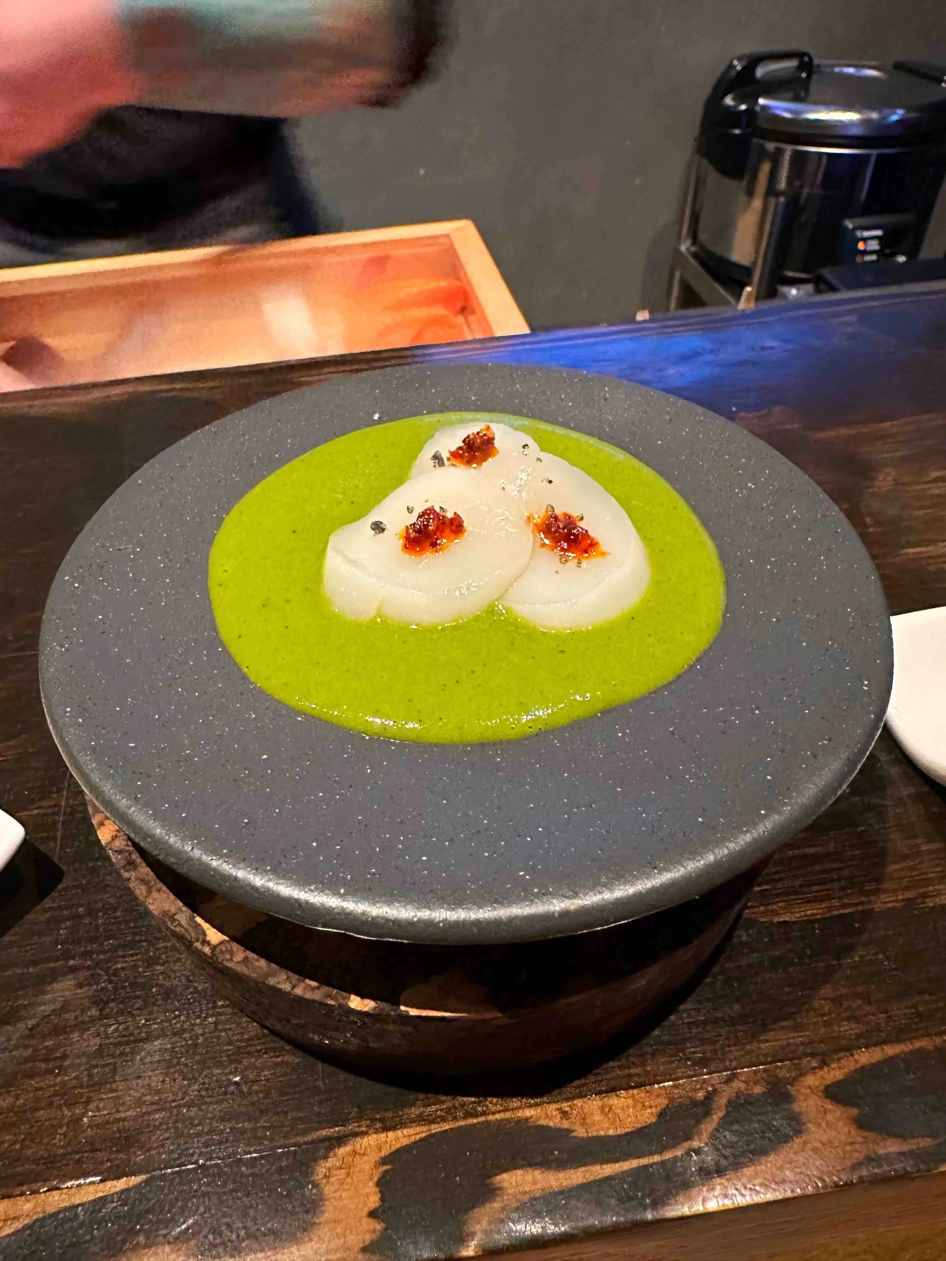 Another view of an intricate sushi piece with unique preparation at Toshokan in Austin