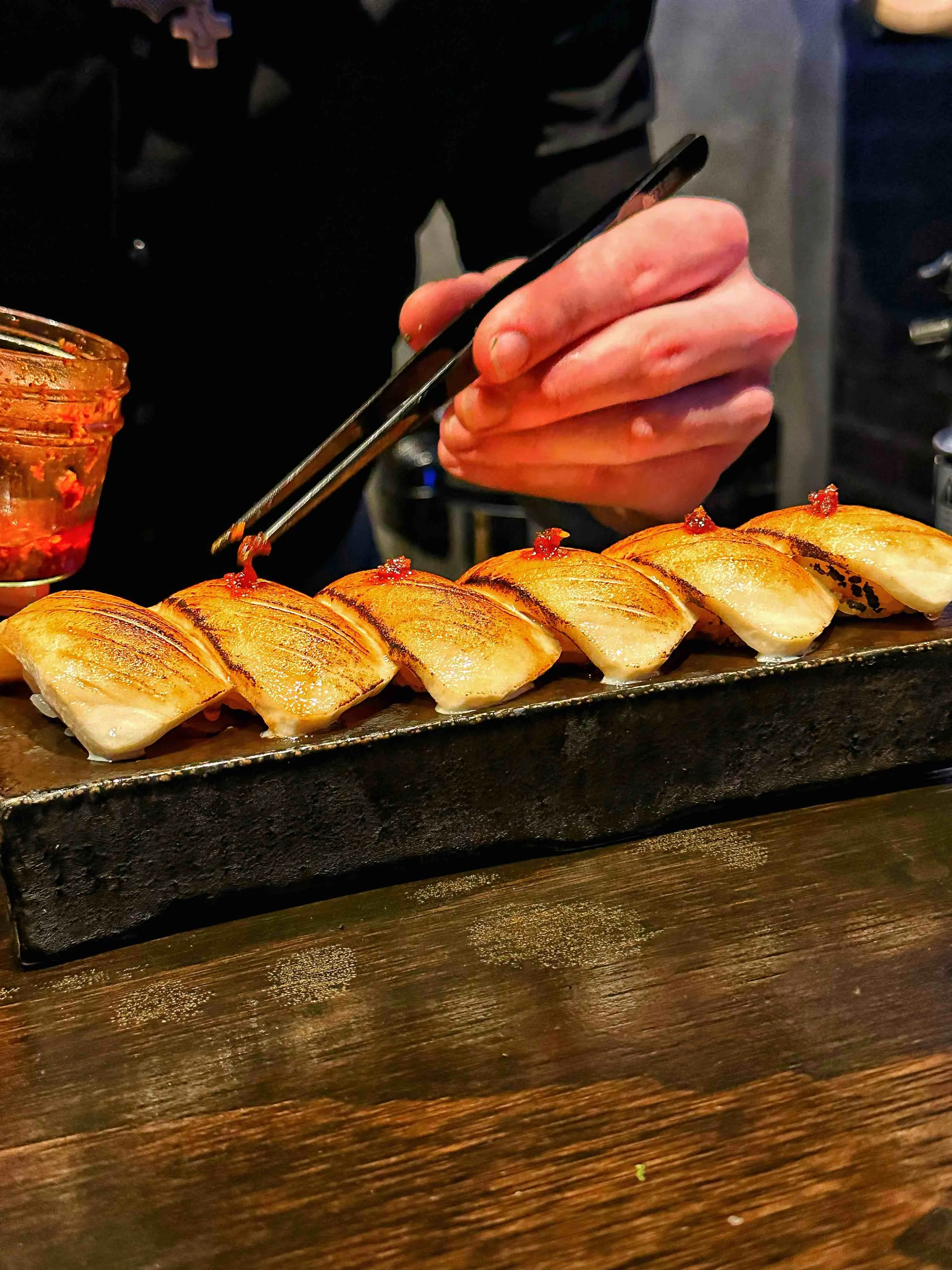 Artfully presented sushi with unique toppings at Toshokan Austin