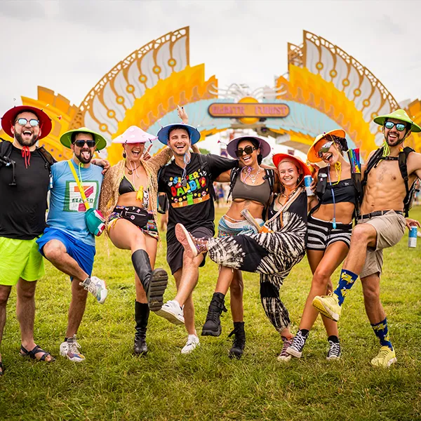 Attendees gathered for a presentation or event at a non-profit partner booth at Electric Forest Michigan