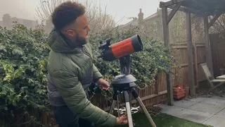 Author operating the Celestron 4SE amateur astronomy telescope in the back yard