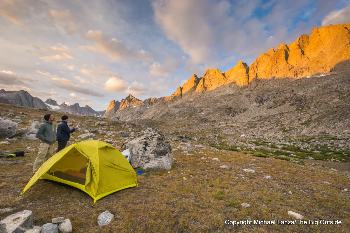 Backpackers watching sunset at a campsite in Titcomb Basin, Wind River Range, Wyoming.
