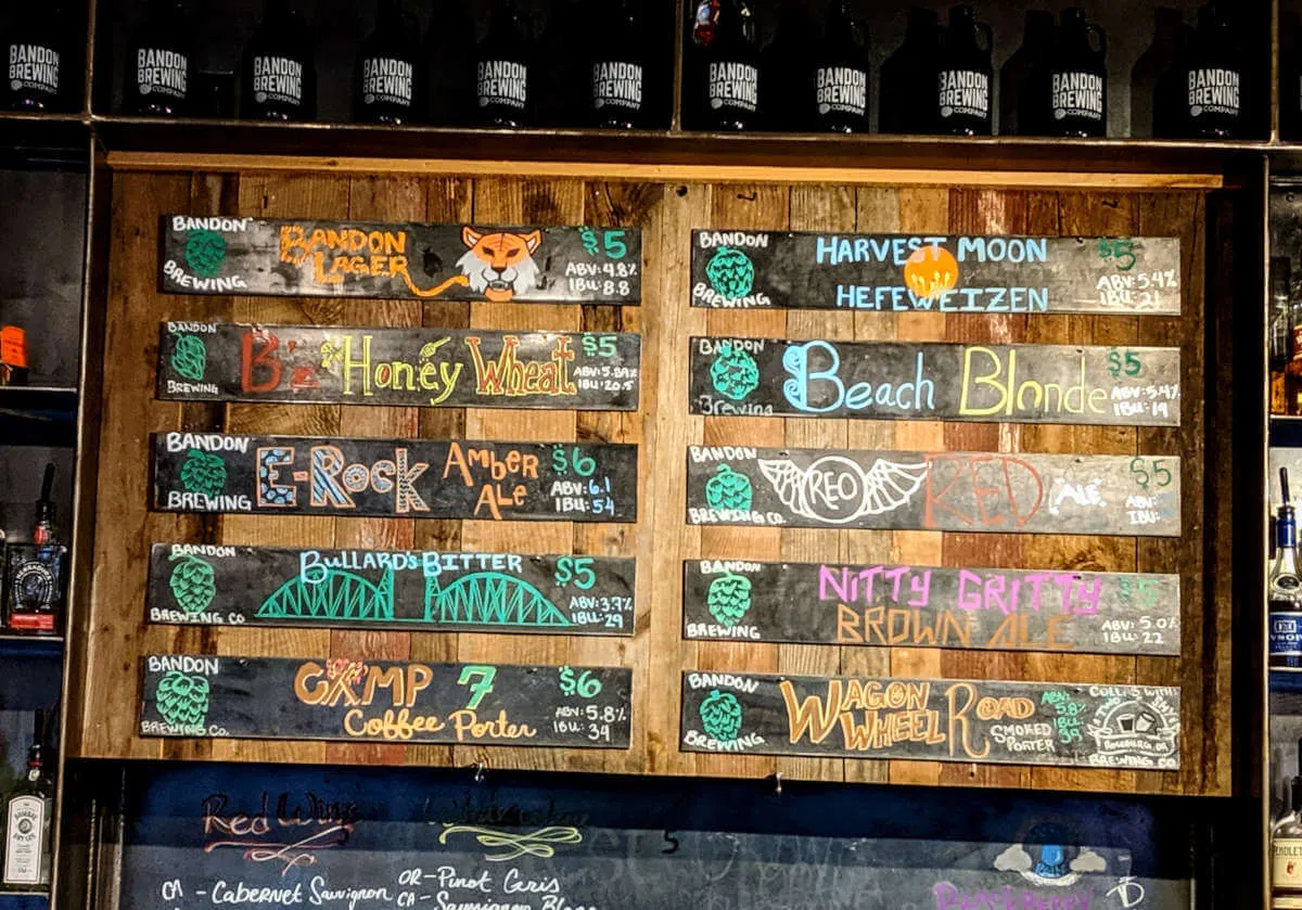Beer menu board at Bandon Brewing Company, showing local craft beer options in Oregon
