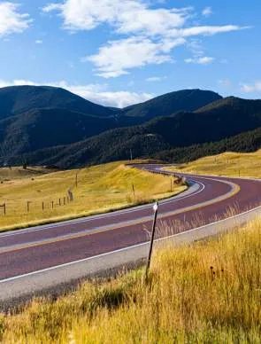 Big Horns-scenic byway with winding road and mountain backdrop.
