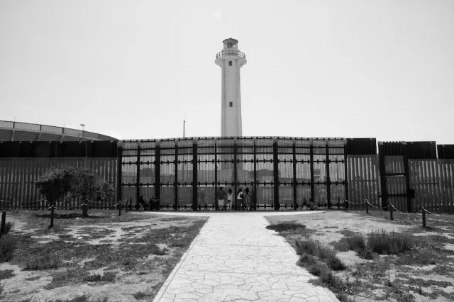 Border fence extending from the land into the ocean at Border Field State Park