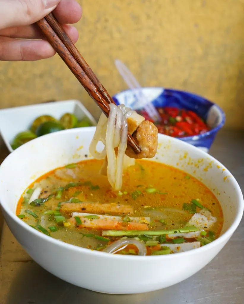 Bowl of Banh Canh noodles with various pork cuts and broth