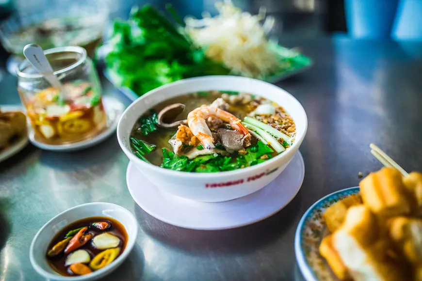 Bowl of Hu Tieu Nam Vang noodles with pork, shrimp, and egg in broth