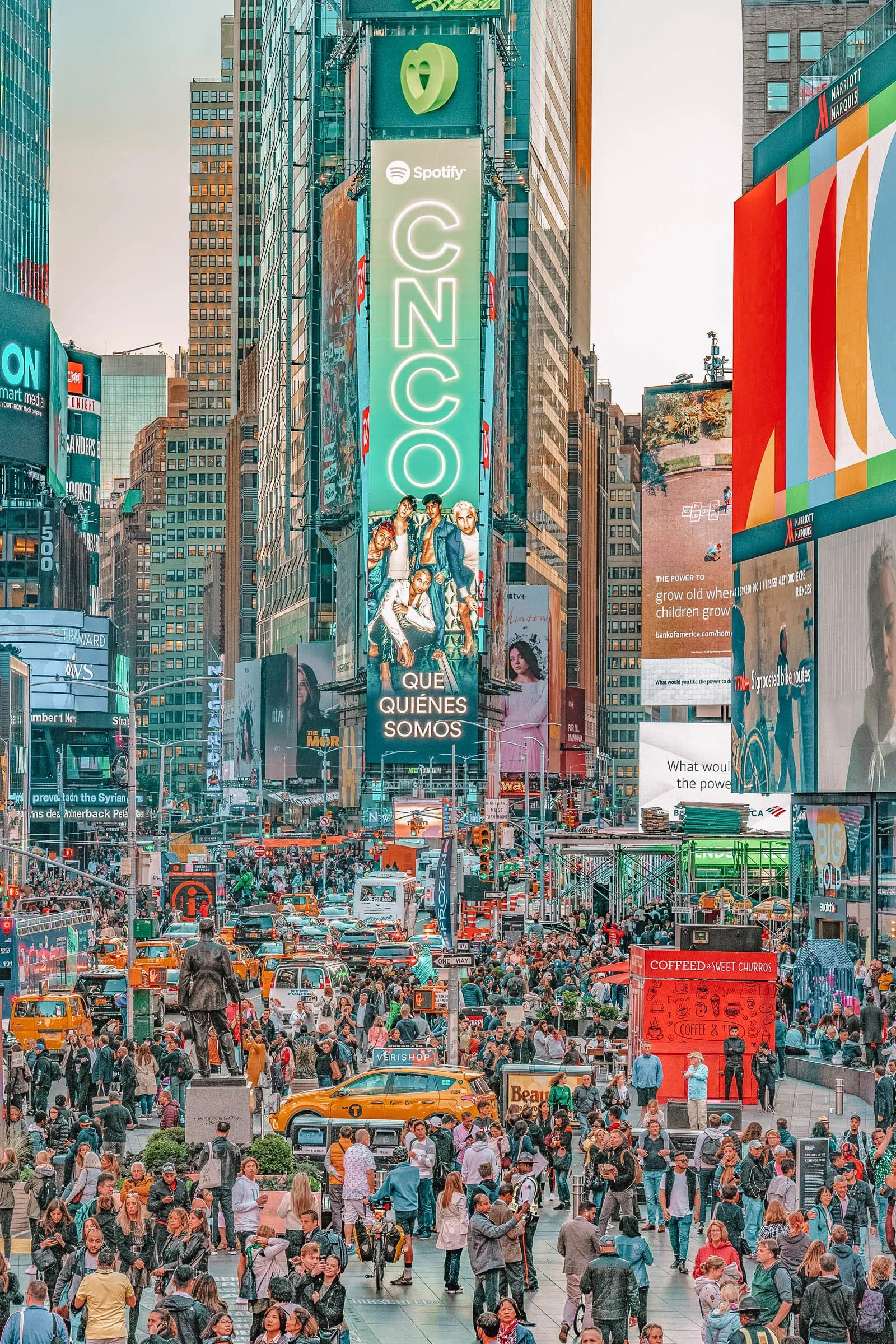 Brightly lit billboards and crowds in Times Square at night