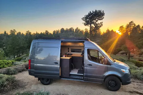 Camper van parked in a large parking lot, an option for finding where can i park overnight for free.