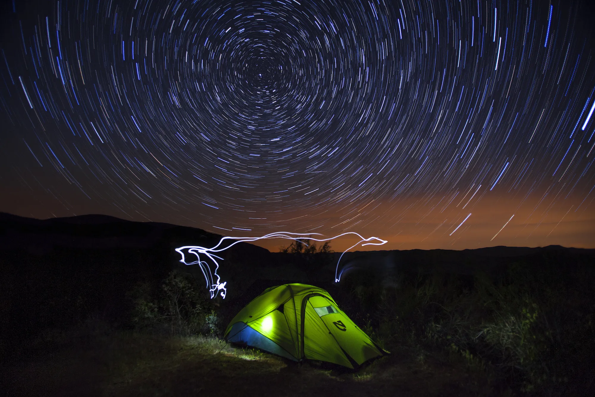 Campsite on Zaca Ridge overlooking a valley at sunset