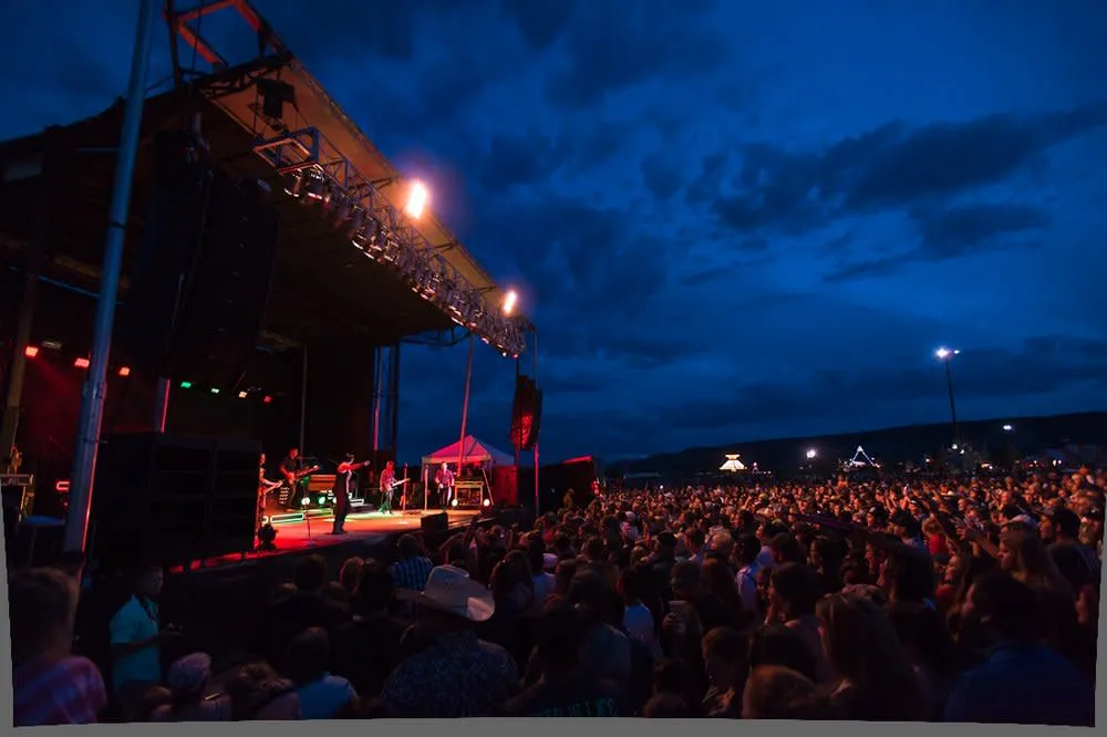 Carnival rides and fairgoers at Wyoming's Big Show, a music festival experience in Rock Springs
