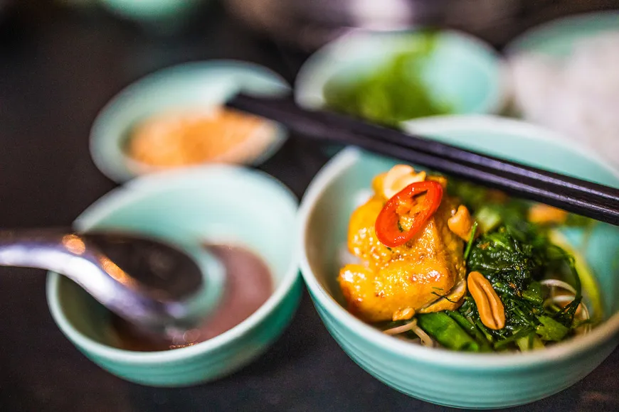 Cha Ca La Vong, turmeric-marinated fish with dill and green onions cooked tableside