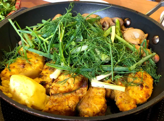 Chả Cá sizzling in a pan, a historical Hanoi Specialty Food