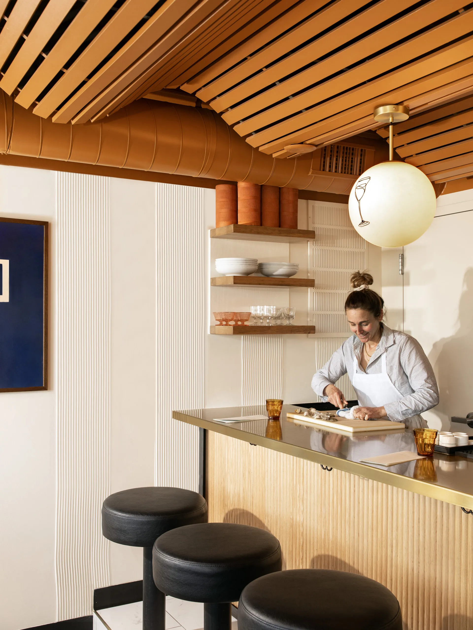 Chef Caroline Glover stands behind the counter at Traveling Mercies bar.