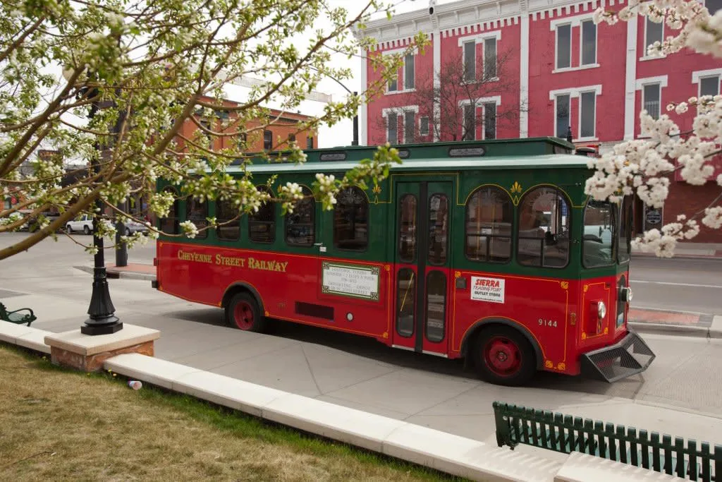 Cheyenne Street Railway Trolley in front of historic buildings - City Tour Things To See And Do In Wyoming