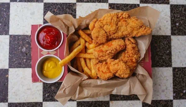 Chicken tenders and fries served with dipping sauces.