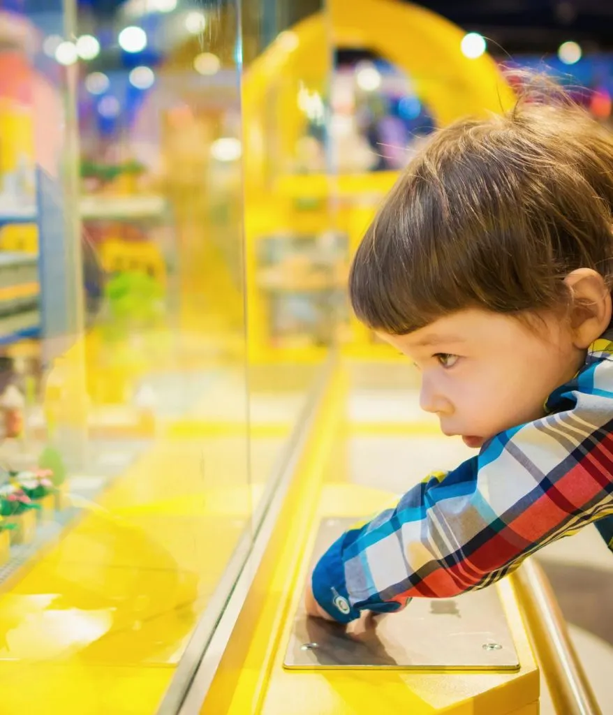 Child looking at toys in a bright, colorful toy store in Rockefeller Center