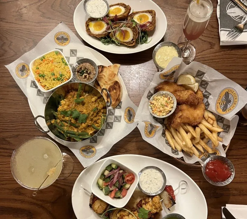 Classic British pub fare like fish and chips and chicken skewers served at the Golden Bee Gastropub in Colorado Springs.