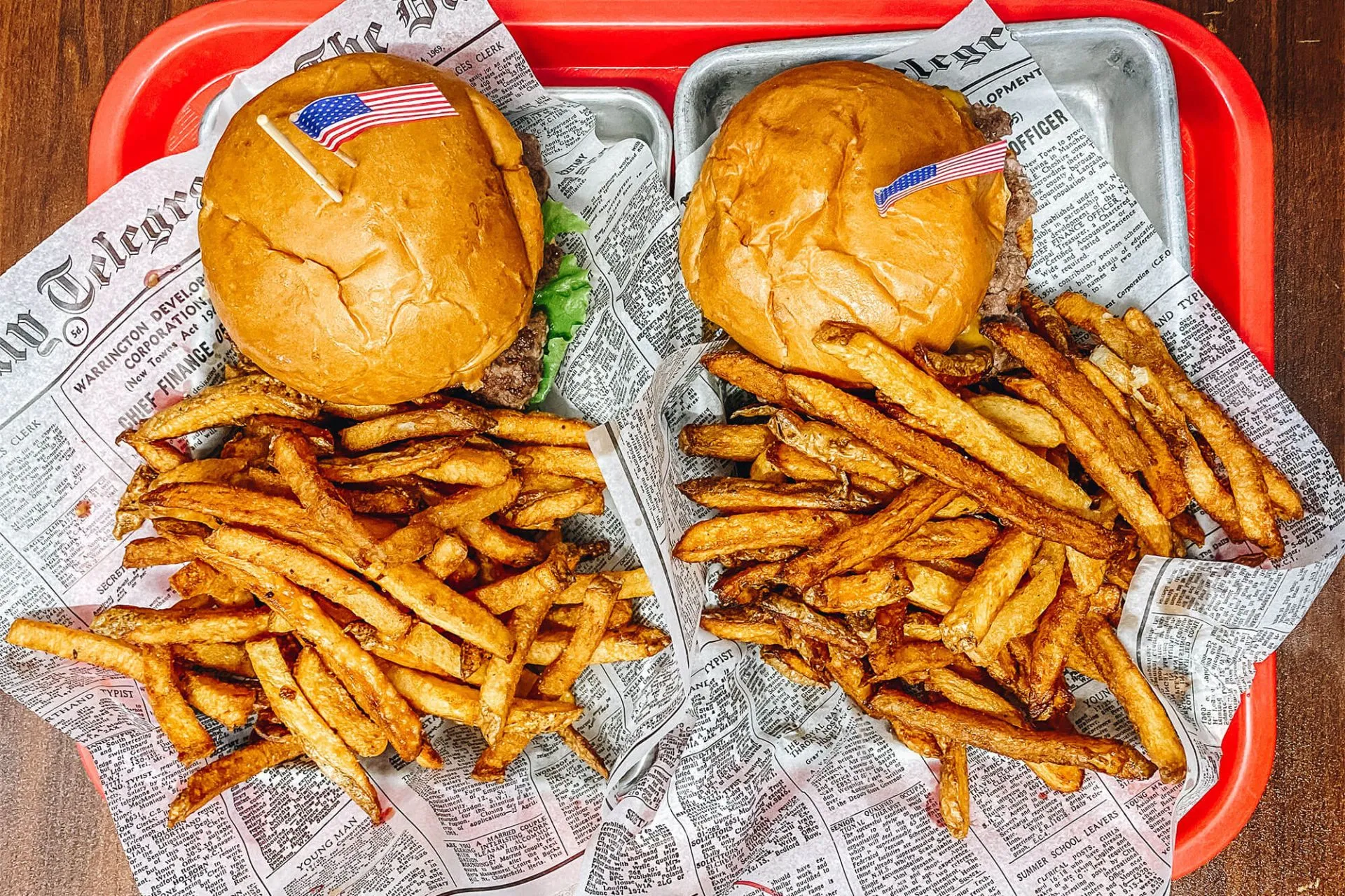 Classic burger and fries served on a red tray with checkered paper at Penelope's Old Time Burgers in Estes Park