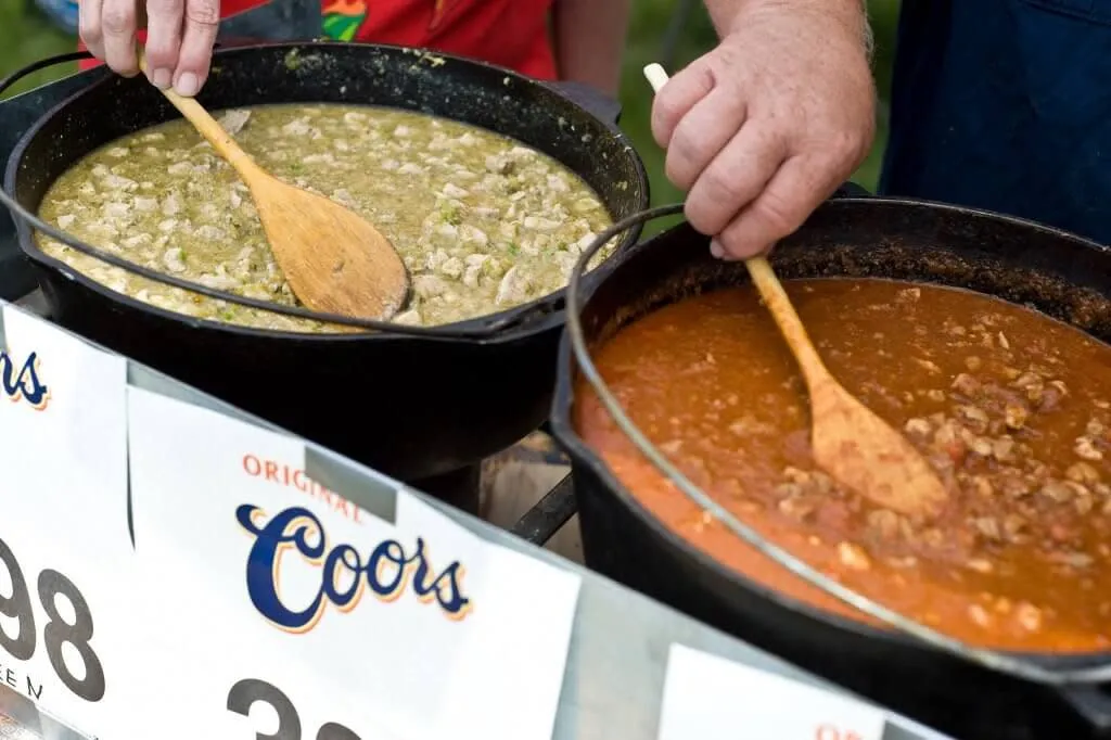 Close-up of pots of green and red chili at the Chugwater Chili Cook-Off - Culinary Things To See And Do In Wyoming