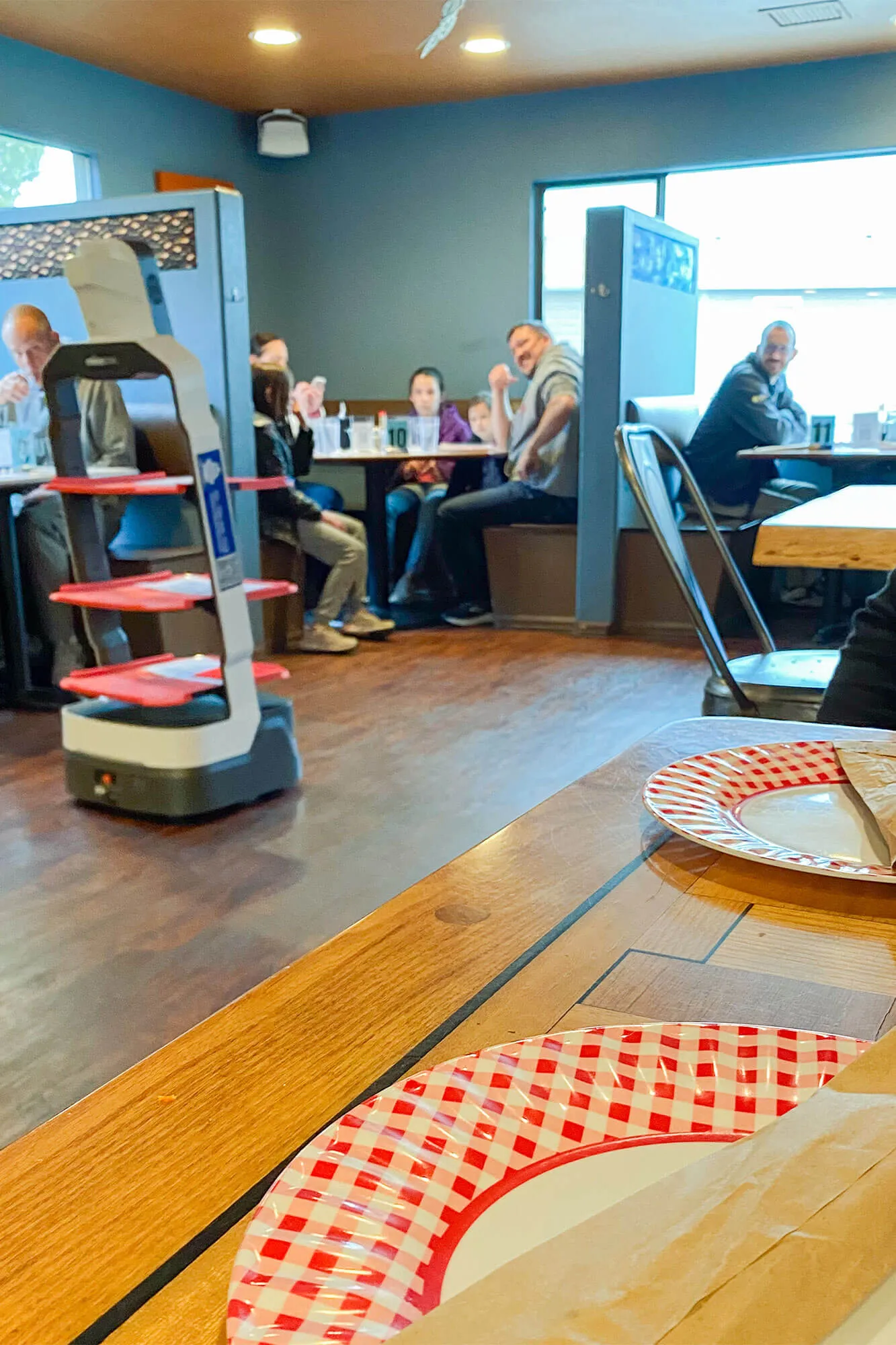 Close-up of robot delivering food trays to a table at Antonio's Real NY Pizza in Estes Park