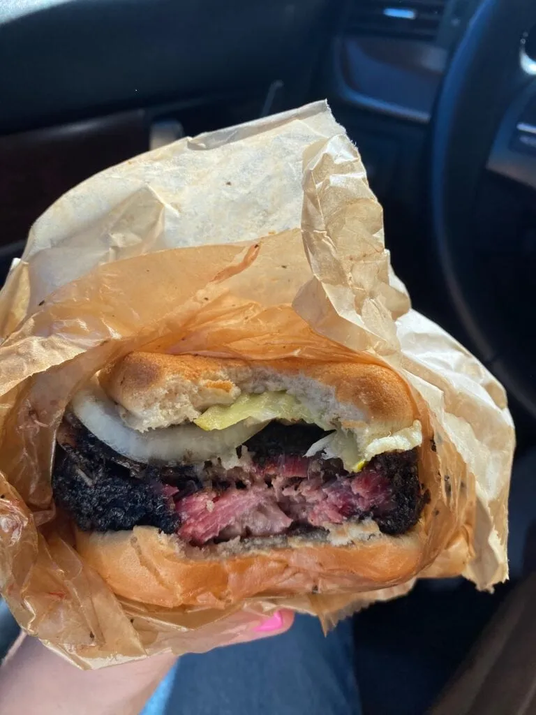 Close-up of smoky brisket from Franklin BBQ, a famous Austin food spot perfect for trying when exploring alone.
