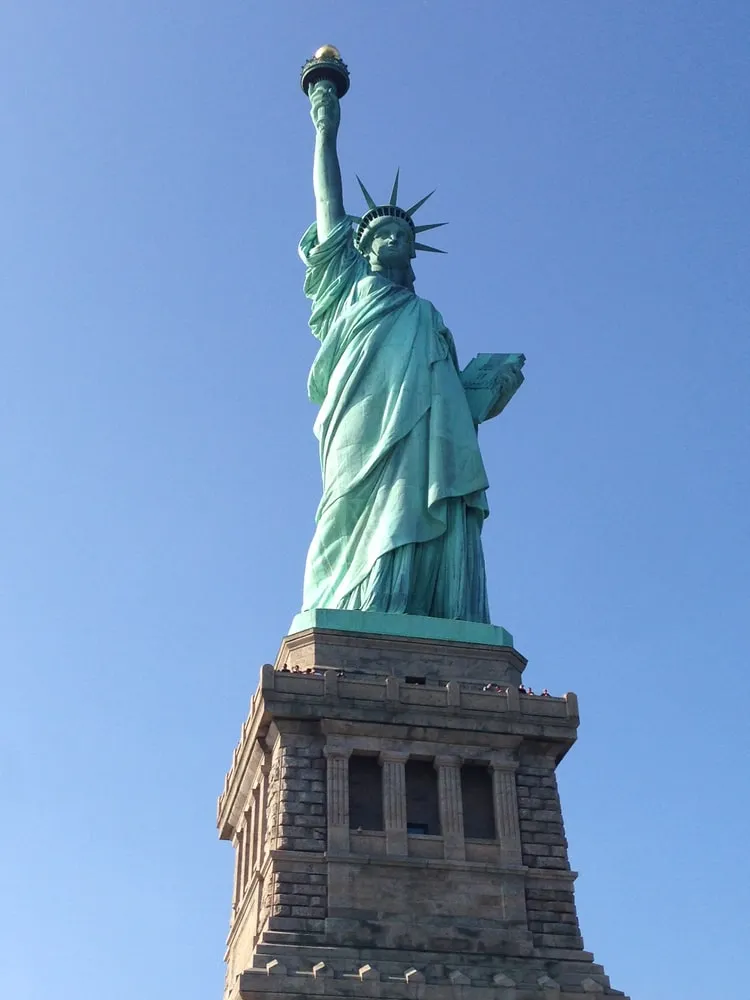 Close-up of the Statue of Liberty from the pedestal level, showing the intricate details of the statue and her base