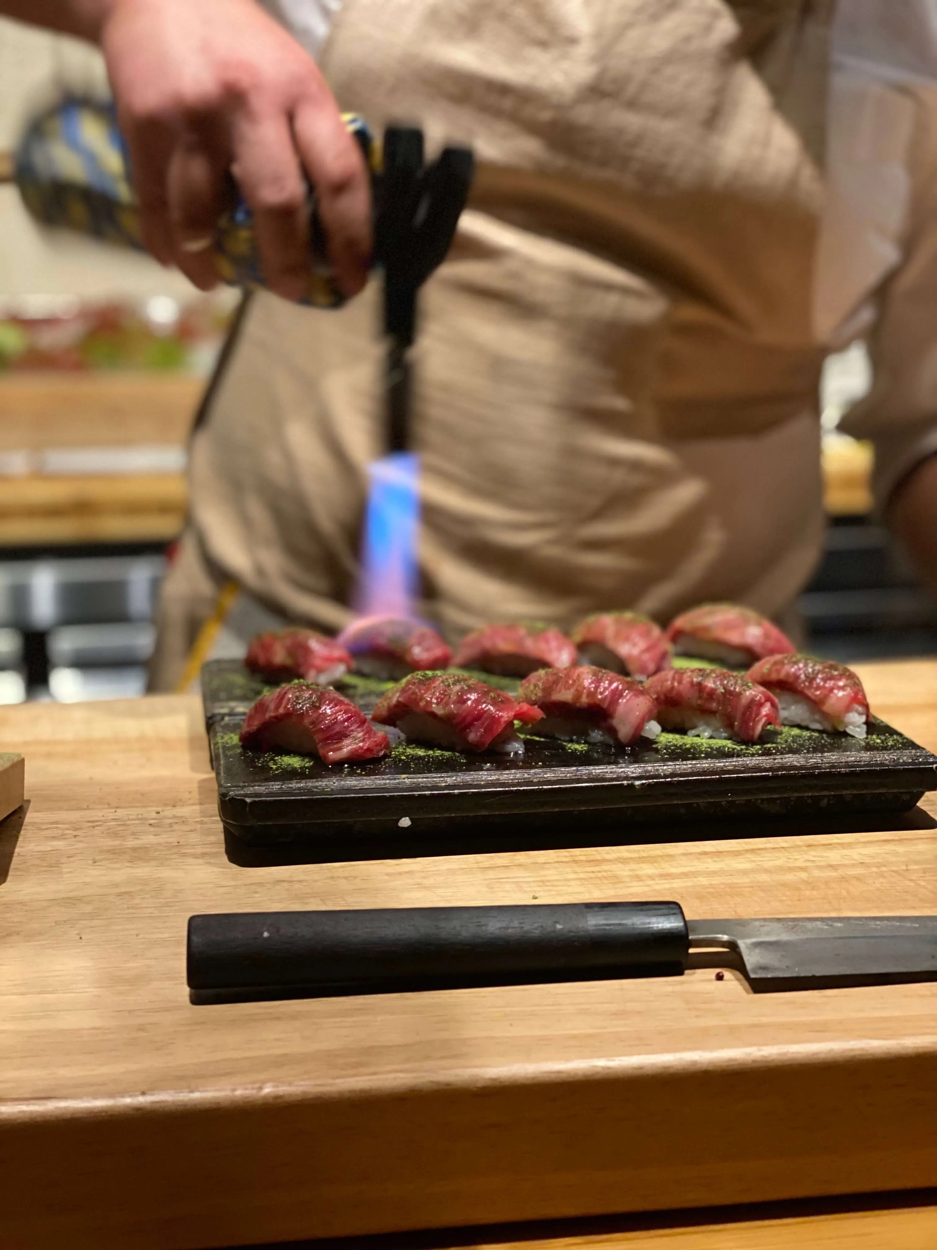 Closeup of intricately prepared nigiri sushi with unique garnishes at Sushi By Scratch Lost Pines