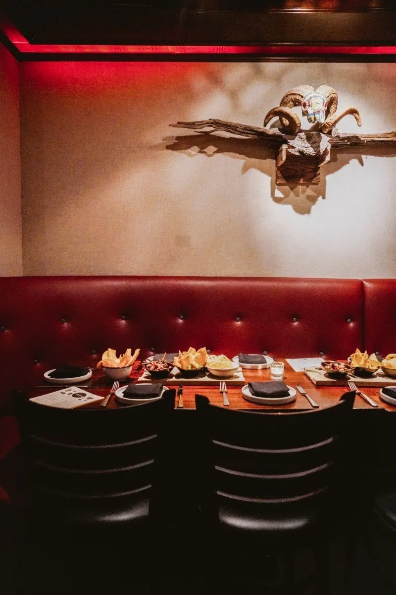 Colorful Oaxacan dishes and cocktails are displayed on a table, showcasing the vibrant food at Cultura Comida y Bebida.