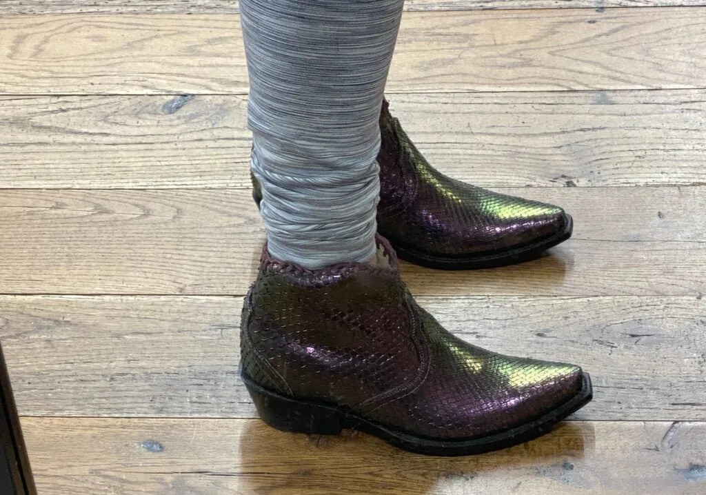 Colorful purple python cowboy boots displayed in Allen's Boots on South Congress Avenue, Austin.