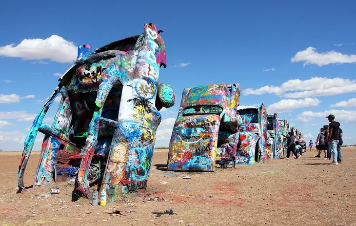 Colorfully painted Cadillac cars buried nose-first into the ground at Cadillac Ranch near Amarillo.