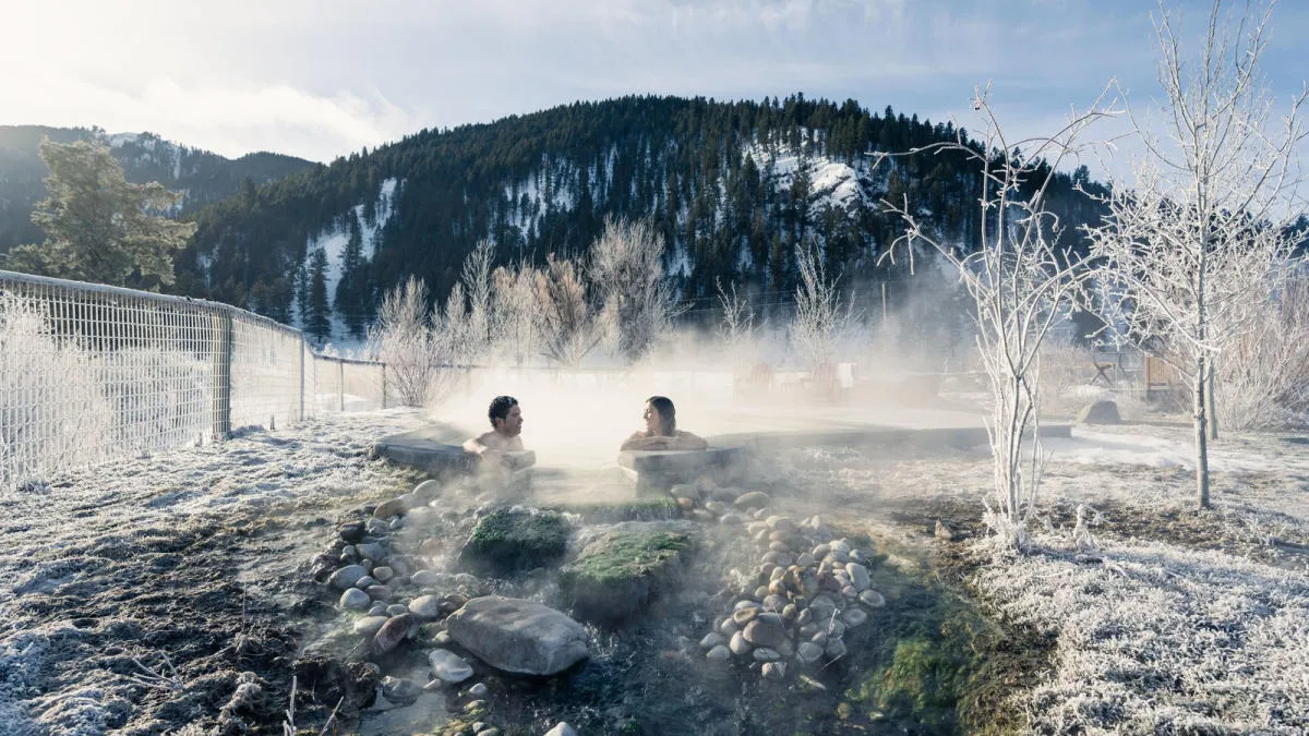 Couple relaxing in the warm pools at Astoria Hot Springs