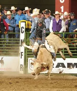 Cowboy riding a bronc at a rodeo event in Casper Wy