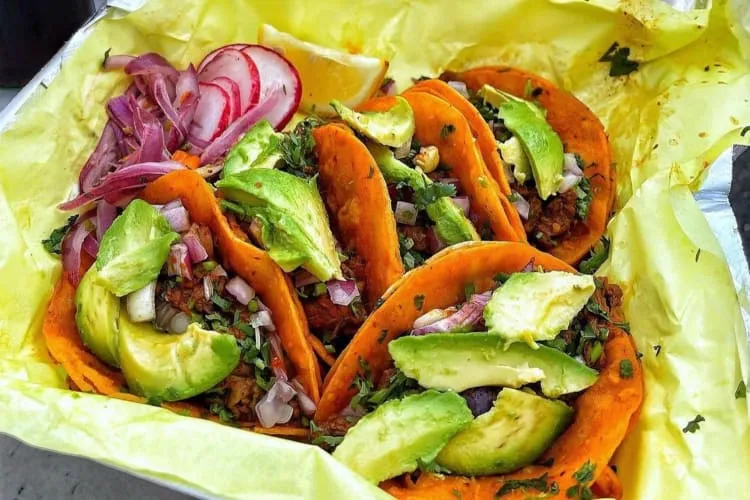 Crispy birria tacos with consomme, a popular Los Angeles food truck dish.