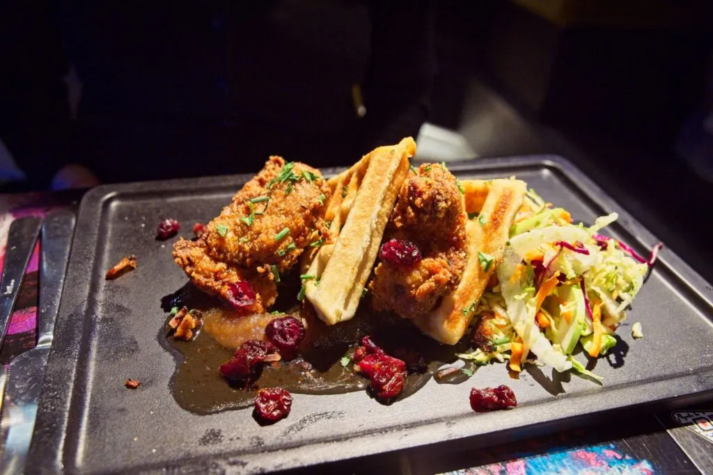 Crispy chicken and buttermilk waffle with harissa honey at Ophelia's, one of the best brunch spots in Denver.