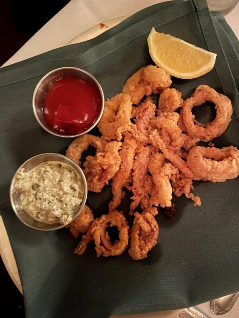 Crispy fried calamari served with dipping sauce at Nello's Place, a classic spot for what to eat in Redding CA