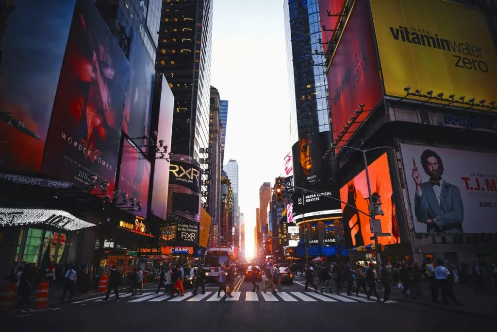 Crowds of people walking and shopping in the vibrant Times Square area of NYC