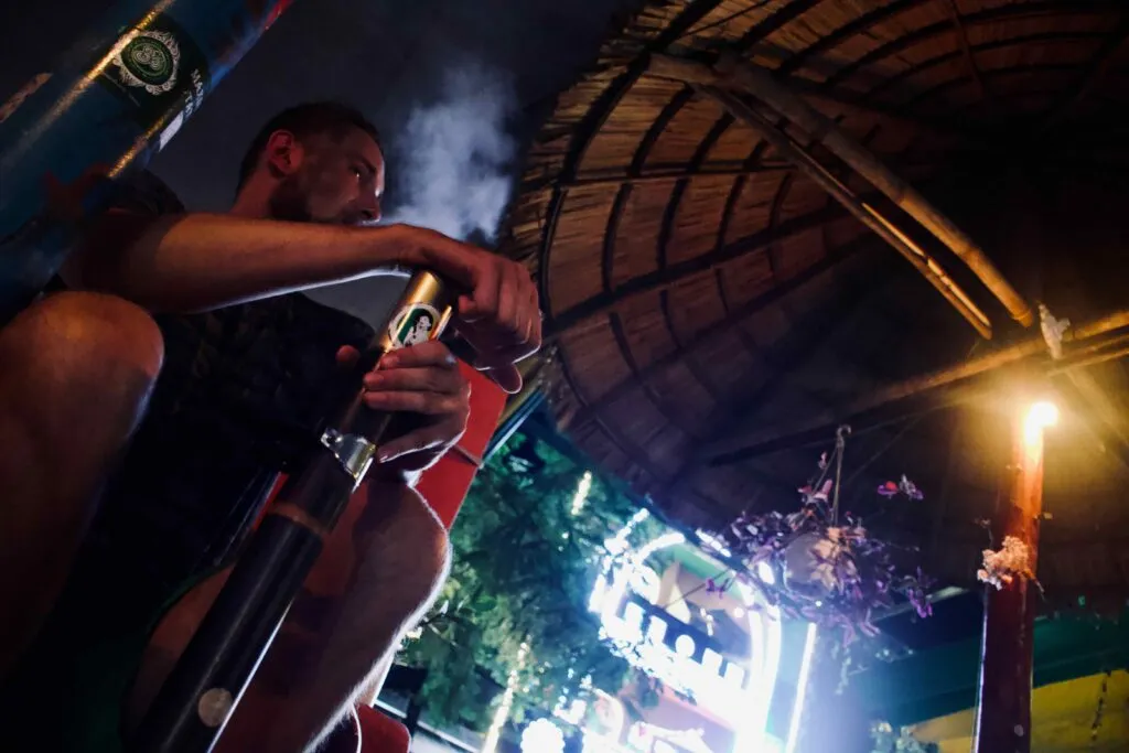 David smoking Thuoc Lao pipe at Heaven Bar
