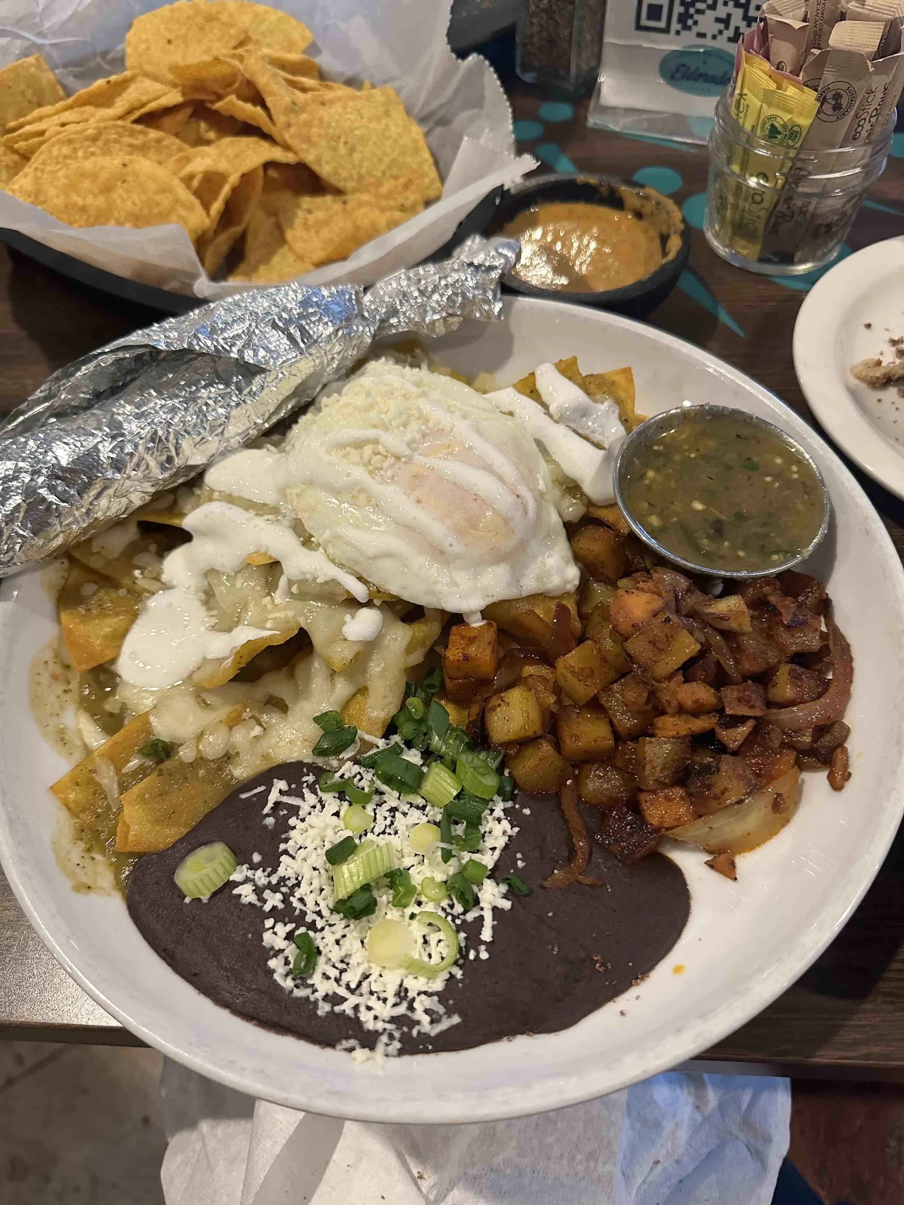 Decadent cheese enchiladas topped with chili, cheese, and a fried egg at ElDorado Cafe in Austin