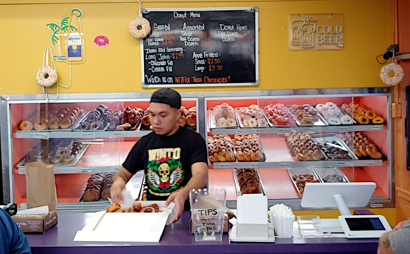 Donut counter displaying various types of donuts at the Original Donut Shop
