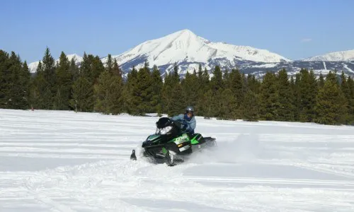 Downhill skiing on powder slopes during trips to Big Sky, Montana.