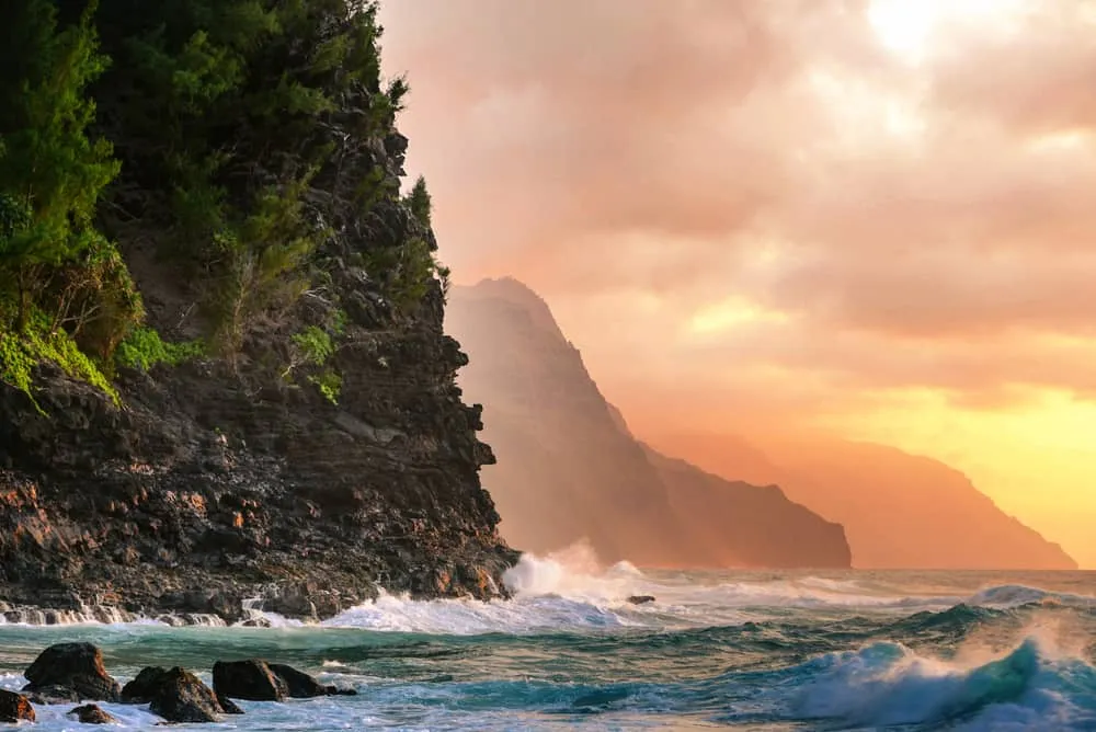 Dramatic green cliffs dropping into the ocean along the Na Pali Coast