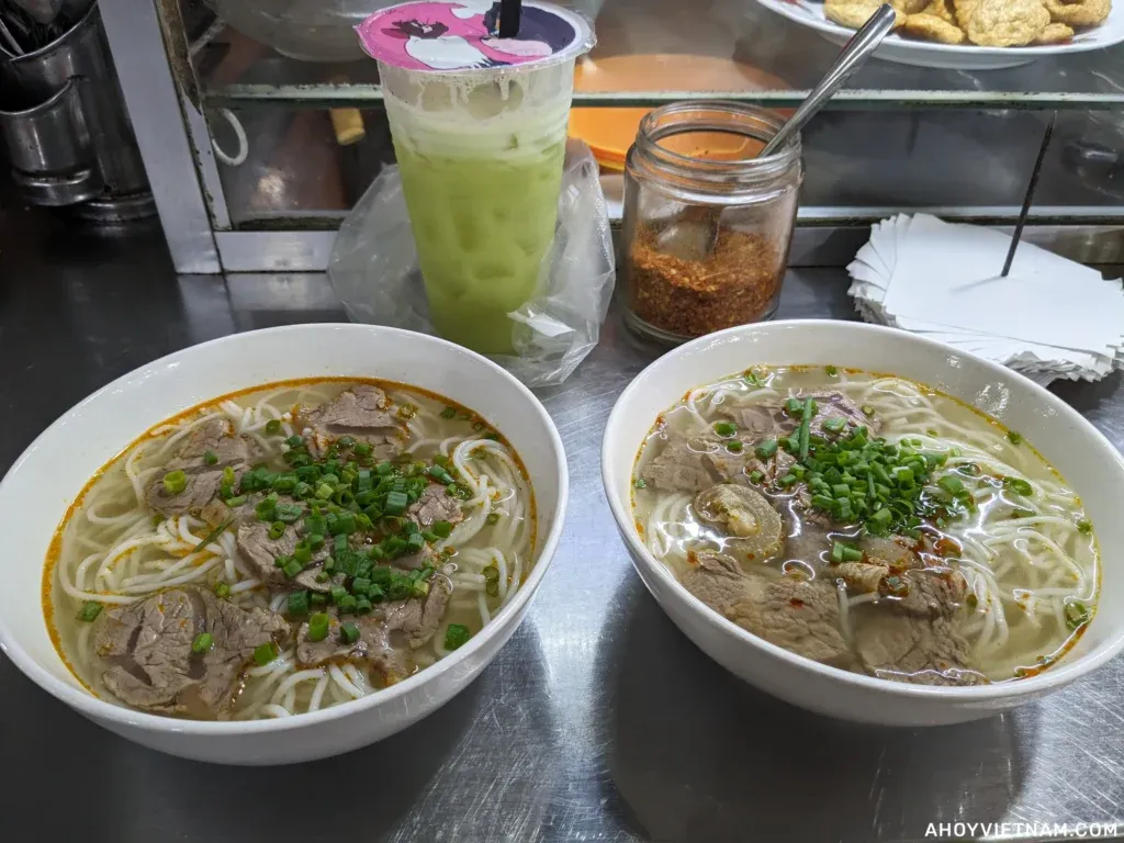 Drinking guava juice and two bowls of bun bo Hue at My An Market, one of the best things to do in Da Nang.