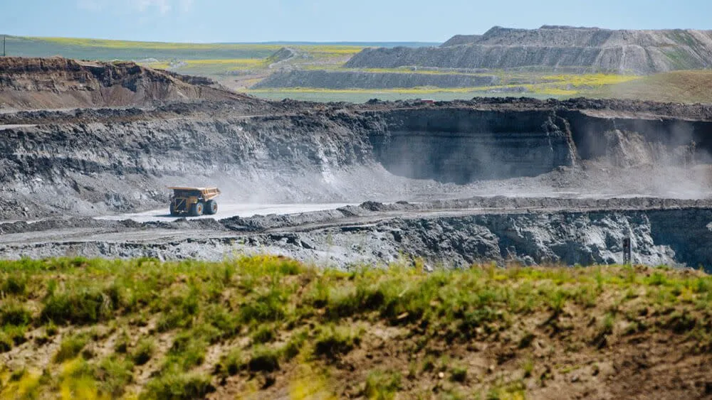 Dump truck in a sprawling rocky landscape at the Eagle Butte Coal Mine - Industrial Things To See And Do In Wyoming