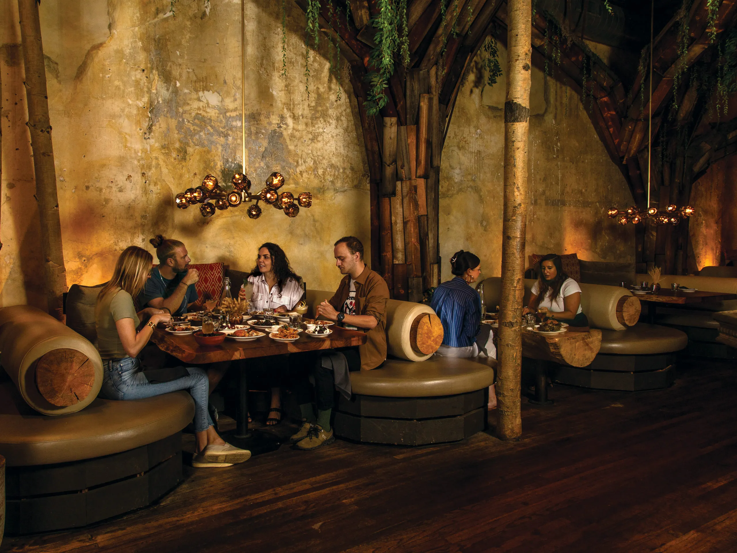 Elegant dining room setting at La Forêt restaurant featuring forest-themed decor